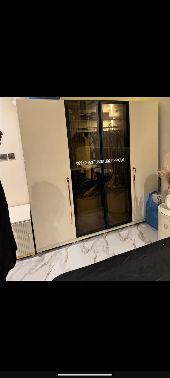 Four-door wardrobe with glass panels and gold handles