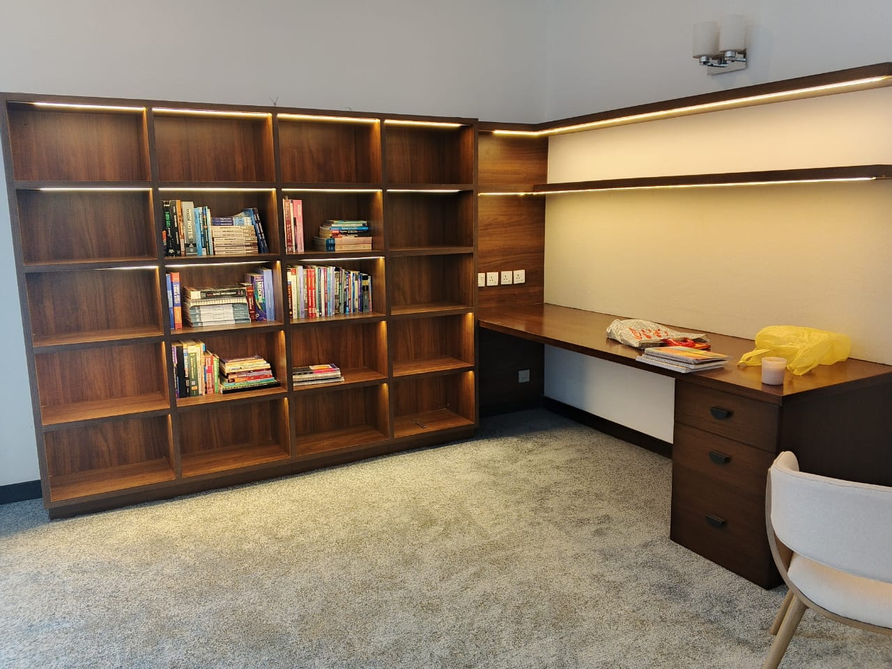 Custom study wall unit with lit walnut shelves