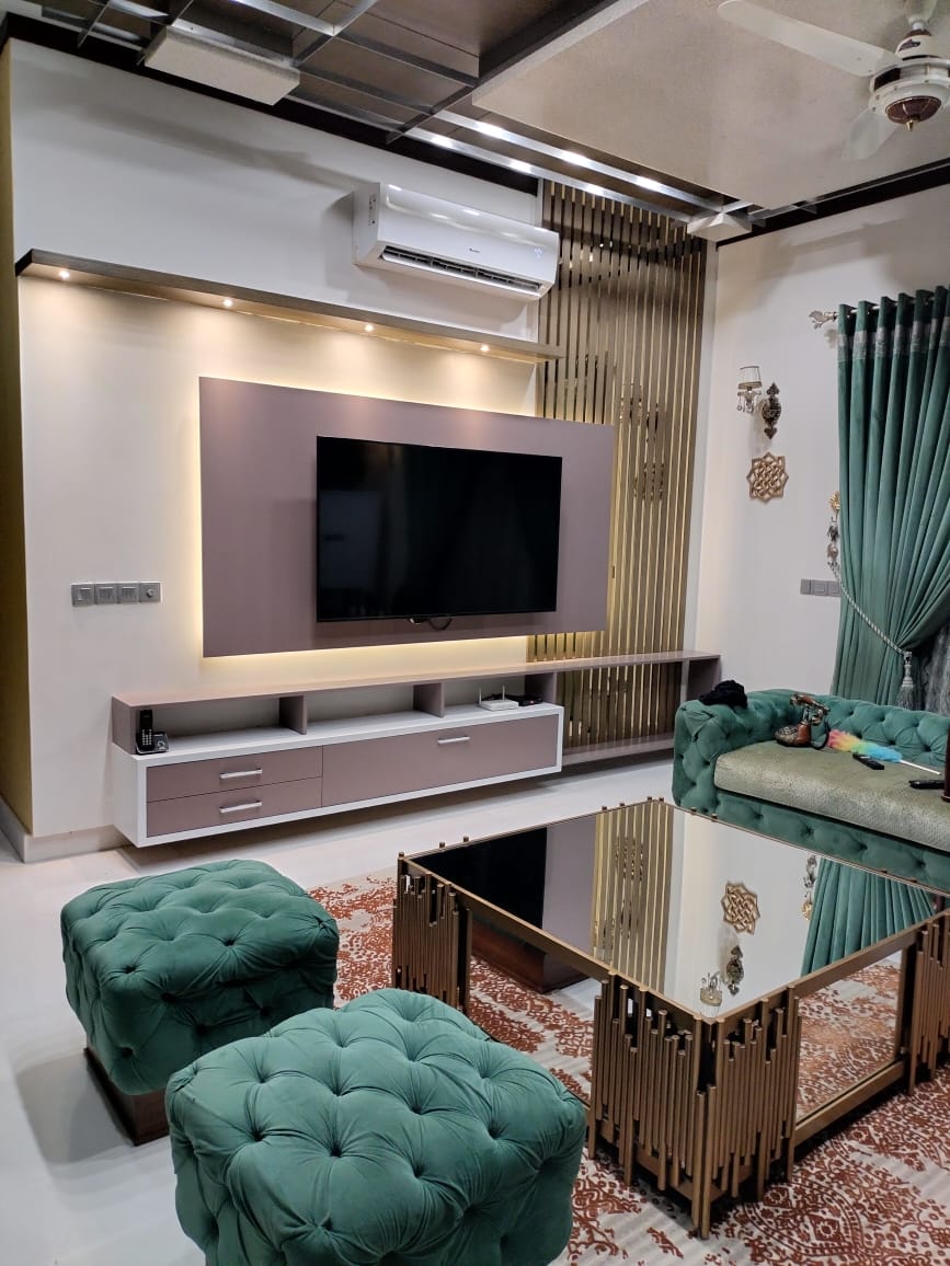 Living room with a custom TV wall and tailored seating